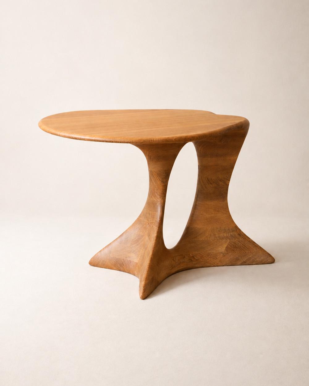 Aphrodite Table by NEXART — A sculptural wooden table with a flowing top and an open architectural base