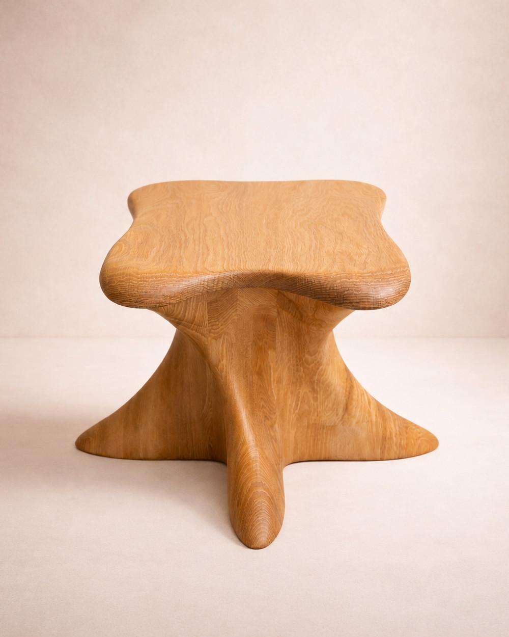 Harmonia by NEXART — A wooden stool with a broad, sculpted seat and softly curved supports