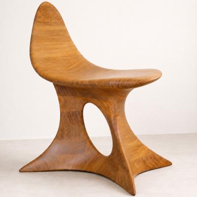 Aphrodite Gen. II by NEXART — A sculptural wooden chair combining a curved seat with an expressive, open base