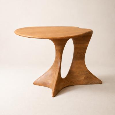 Aphrodite Table by NEXART — A sculptural wooden table with a flowing top and an open architectural base