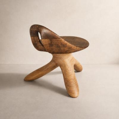 Morphe by NEXART — A sculptural wooden chair with a wraparound seat and a distinctive three-legged form