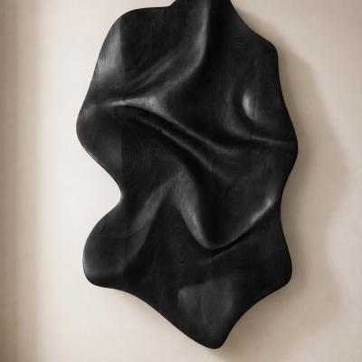 Rheon by NEXART — A sculptural wall object with folded, flowing contours and a dark finish